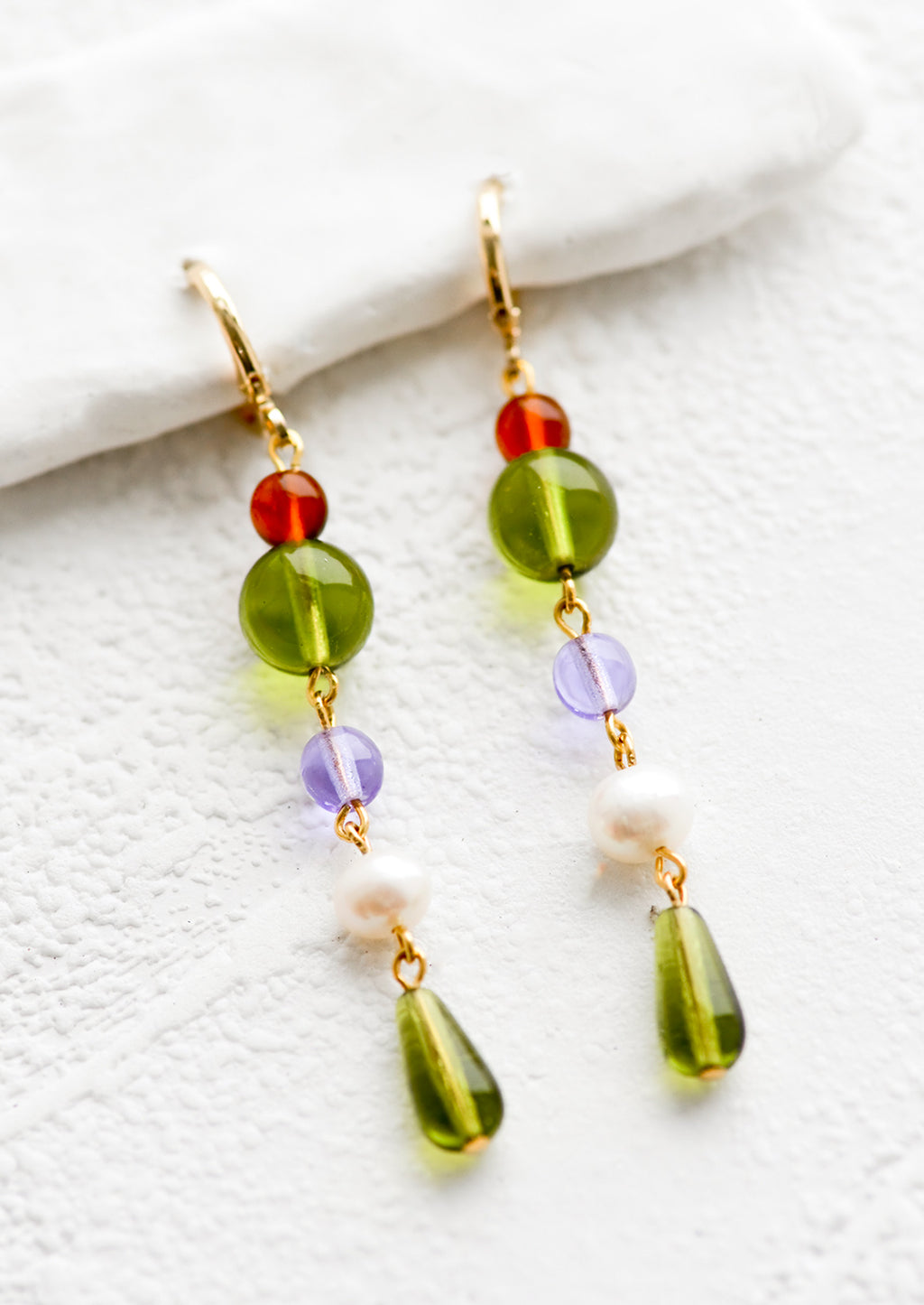 Green Multi: A pair of drop earrings with a beaded strand of colored glass beads with pearl detailing.