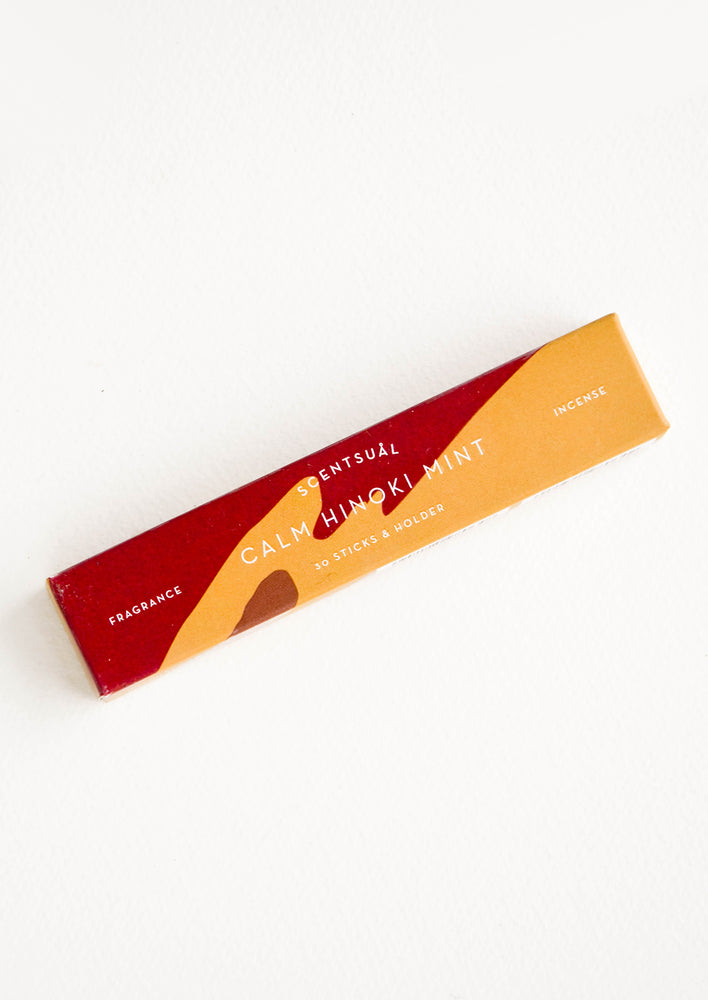 Patterned box in dark red and orange, containing 30 incense sticks in mint scent
