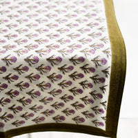 2: A purple and olive green floral print tablecloth.
