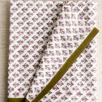 1: A purple and olive green floral print tablecloth.