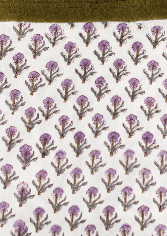 3: A purple and olive green floral print tablecloth.