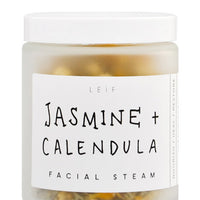 Jasmine + Calendula: A frosted glass jar with a black and white label and white plastic lid.