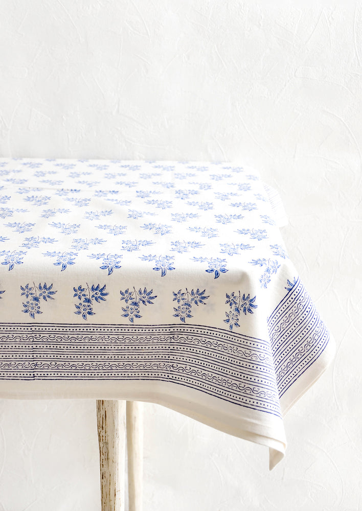 White cotton tablecloth with blue floral print and patterned border