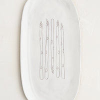 Asparagus: An oval shaped ceramic serving platter with hand drawn asparagus illustration at center.