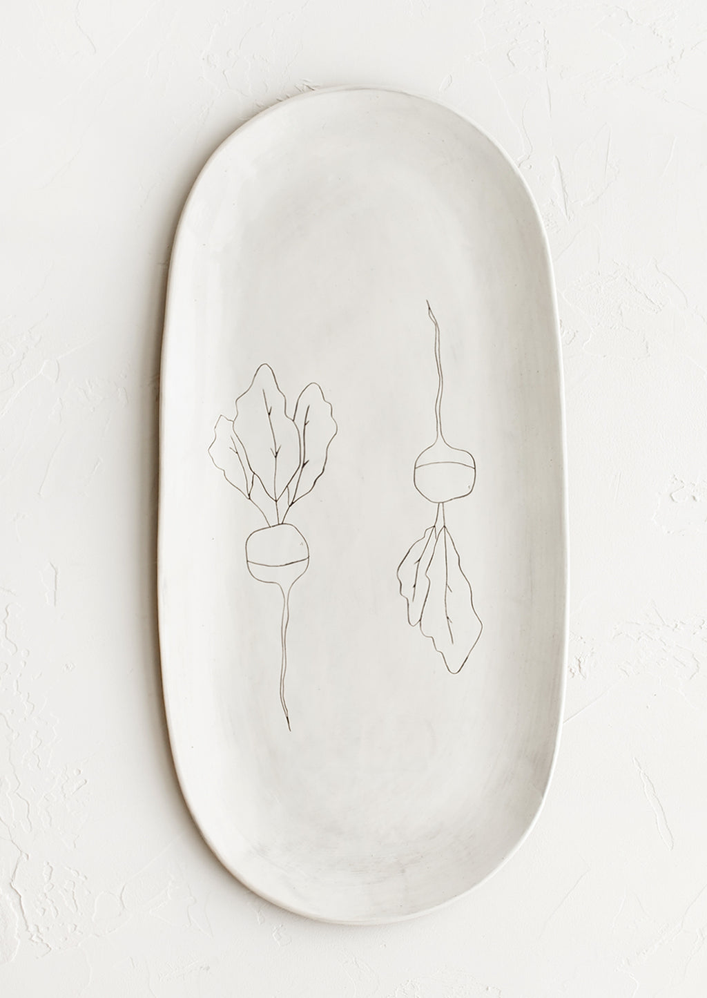 Radish: An oval shaped ceramic serving platter with hand drawn radish illustration at center.