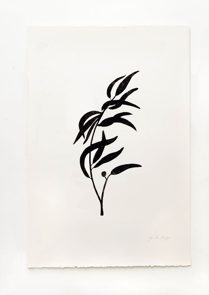 Hand printed artwork with off-white background and black silhouette of eucalyptus branch