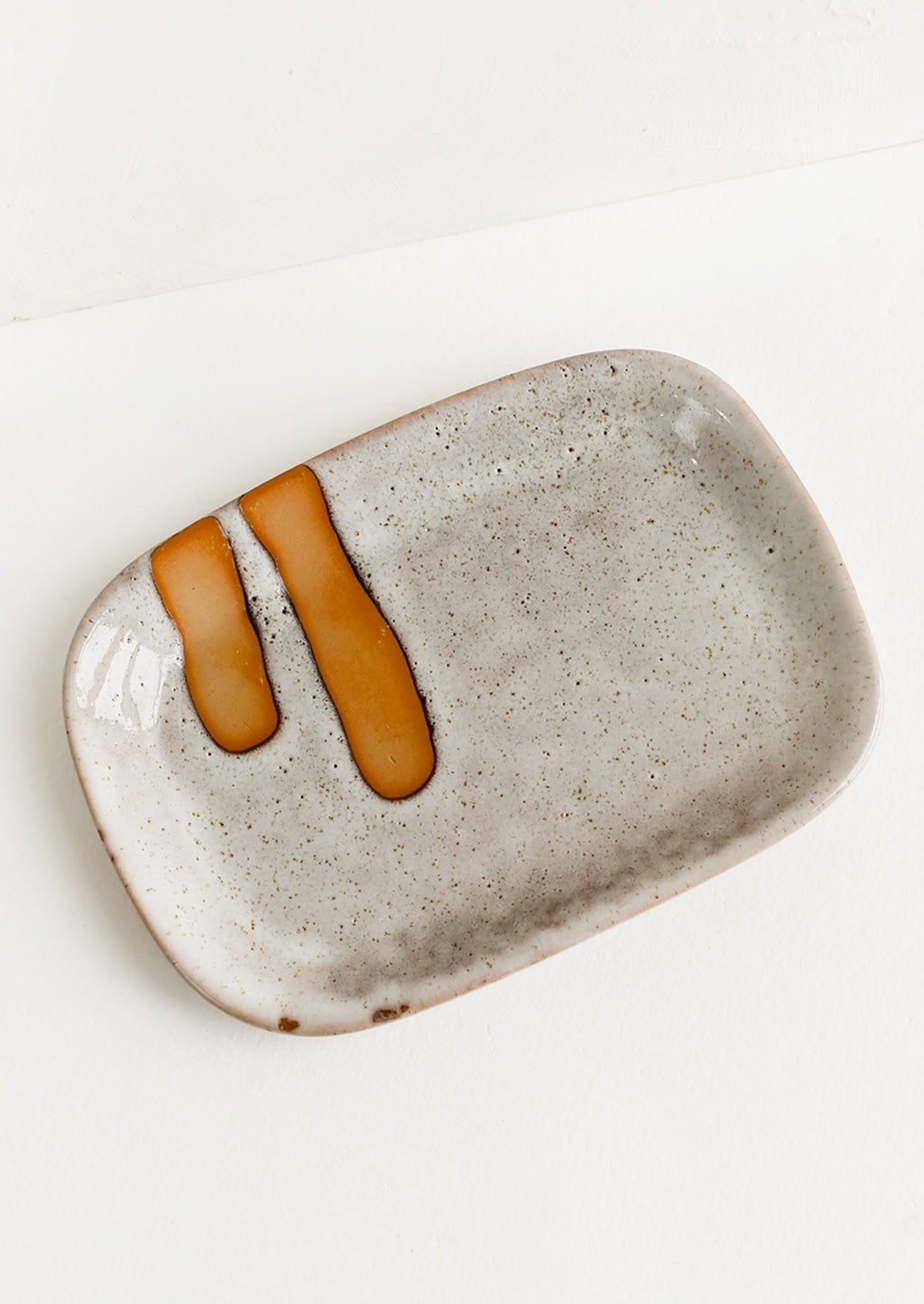 1: A rectangular ceramic dish with stroke detail.
