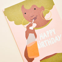 2: Greeting card with illustration of girl with green hair, drinking orange soda with "Happy Birthday" written on her pink t-shirt