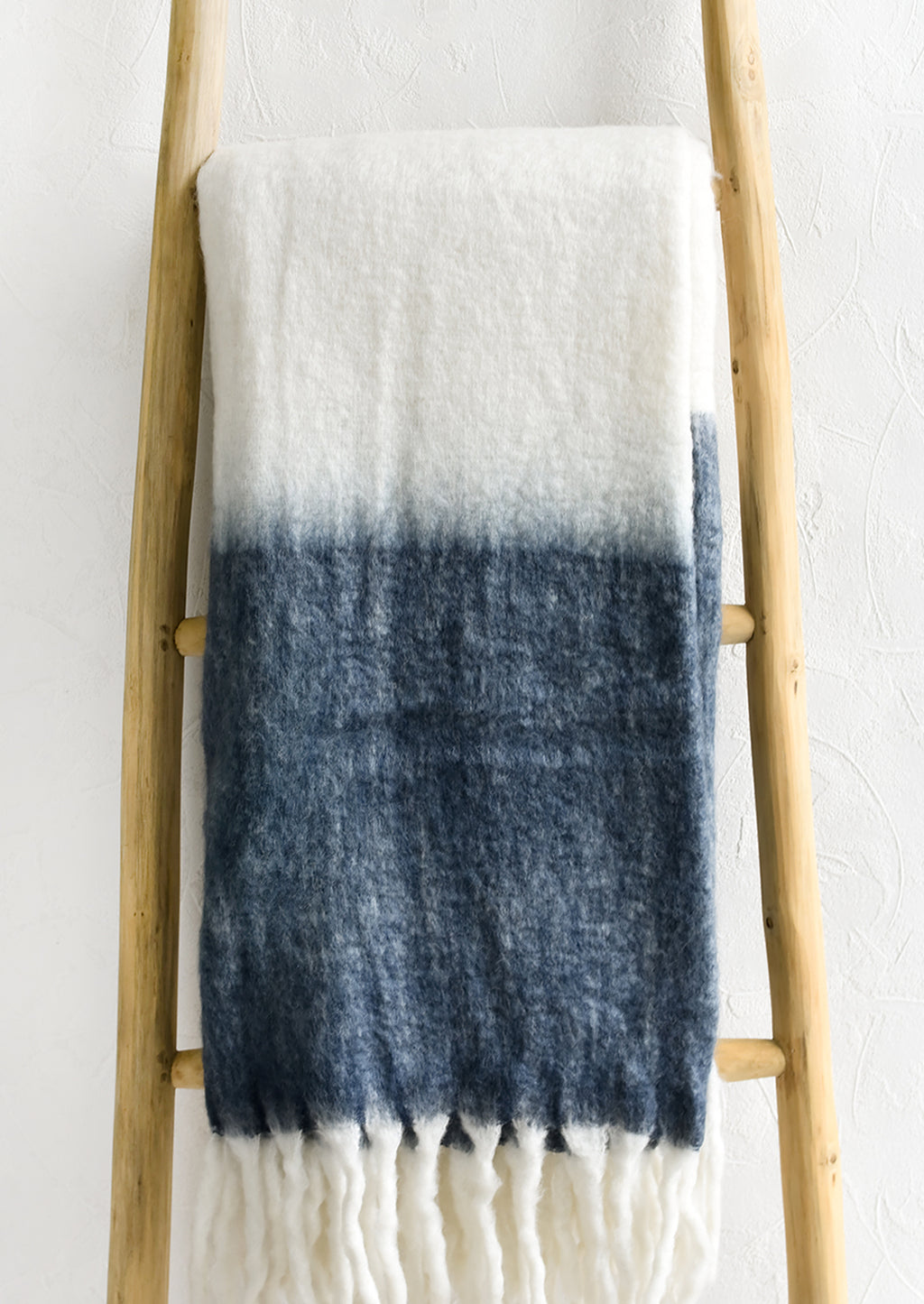 Stone Blue: A mohair throw blanket in white and stone blue with long fringe trim.