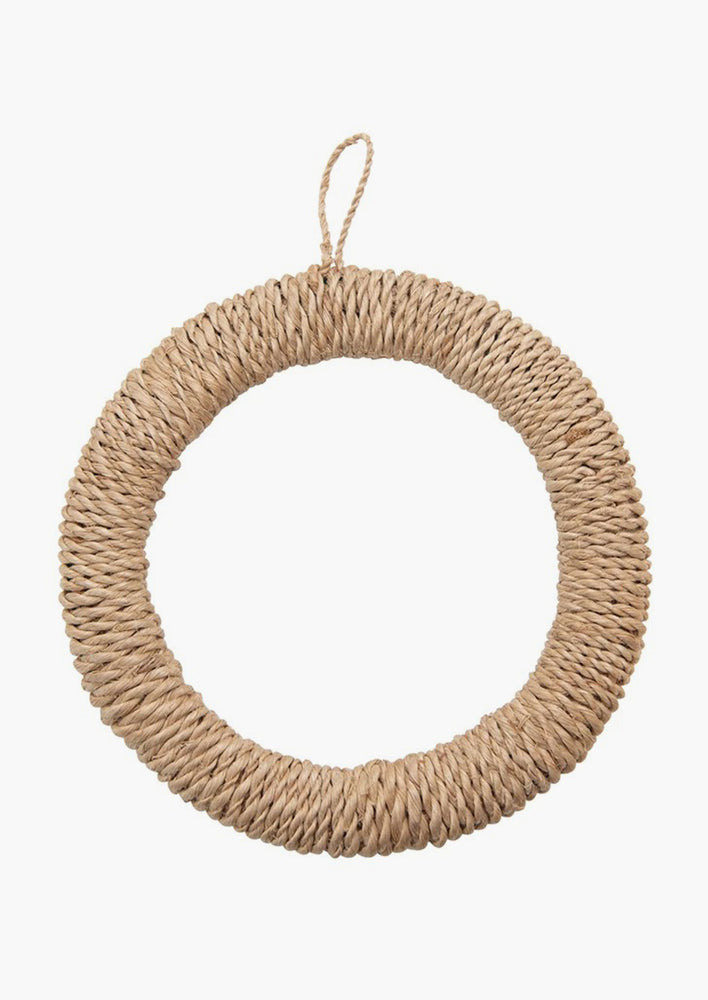 A round woven trivet in natural made from dried abaca.