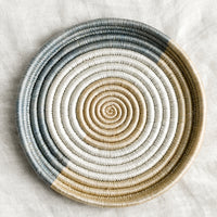 Dusty Blue / Sand / White: A round, shallow sweetgrass tray in dusty blue, white and tan.