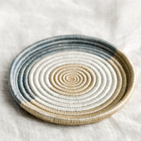 3: A round, shallow sweetgrass tray with lipped edge.
