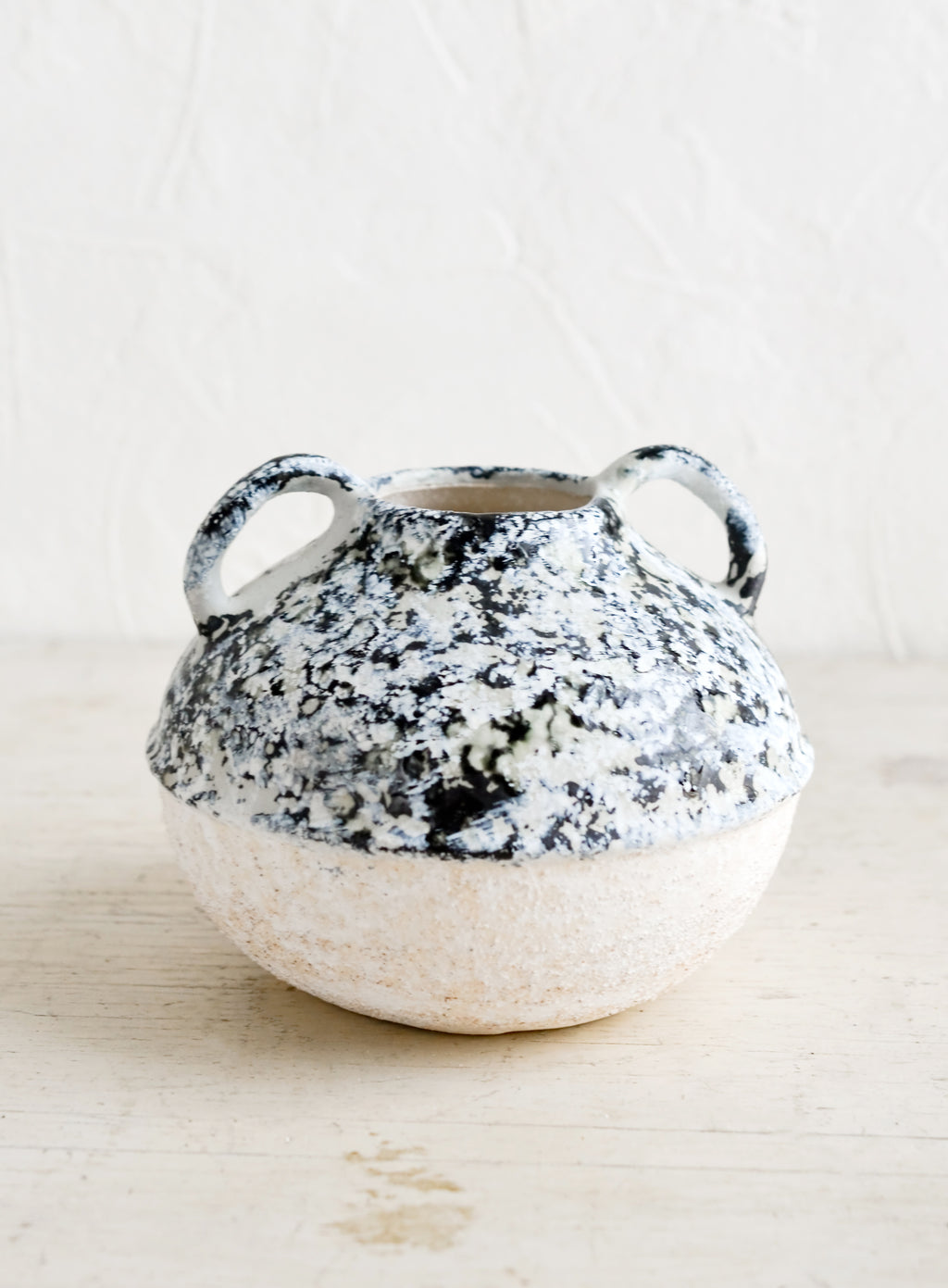 Small: A distressed ceramic vase in short shape with side handles.