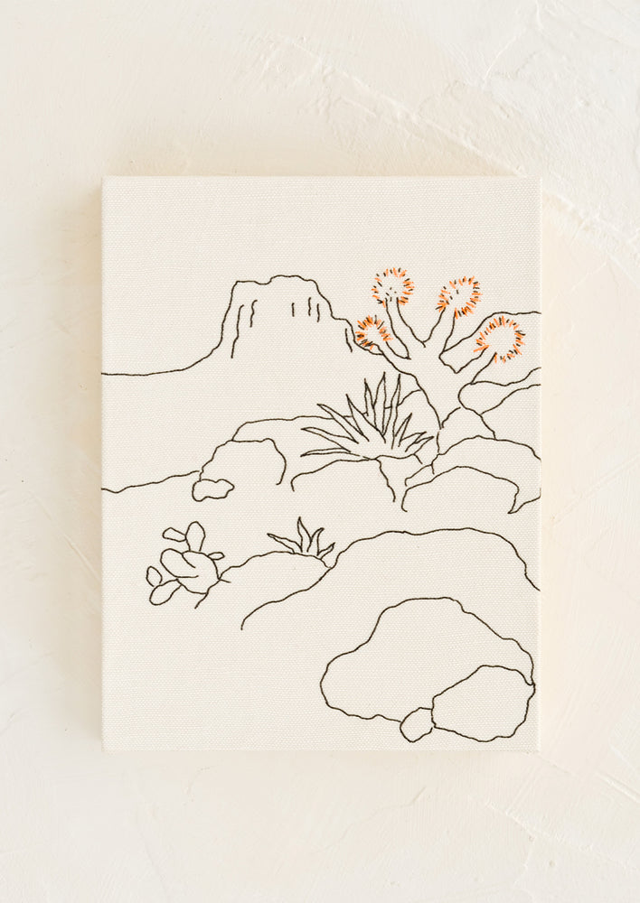 Natural: A white cloth covered journal with desert themed embroidery.