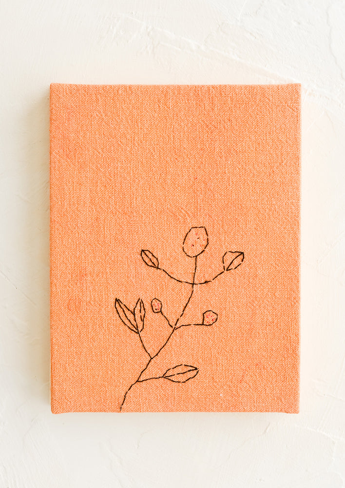 Peach: A peach cloth covered journal with botanical embroidery detail.