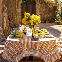 1: A stripe floral print tablecloth in marigold, purple and blue.