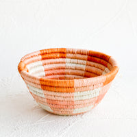 Peach / Terracotta: Small woven catchall bowl made from sweetgrass in a peach and terracotta geometric design.