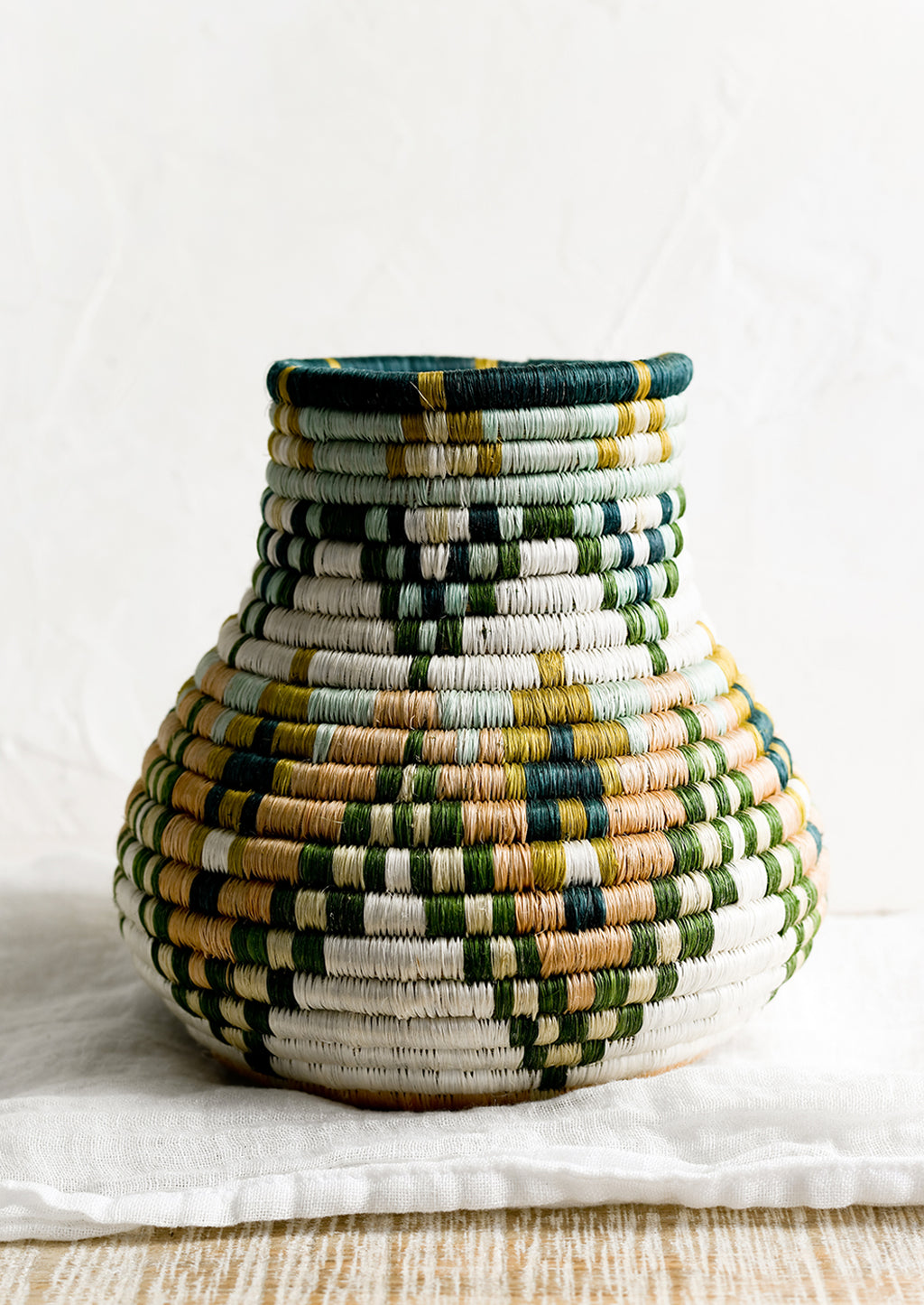 2: A sweetgrass woven vase with bulbous shape.