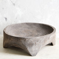 1: Round, primitive style shallow wooden display bowl with chunky footed base