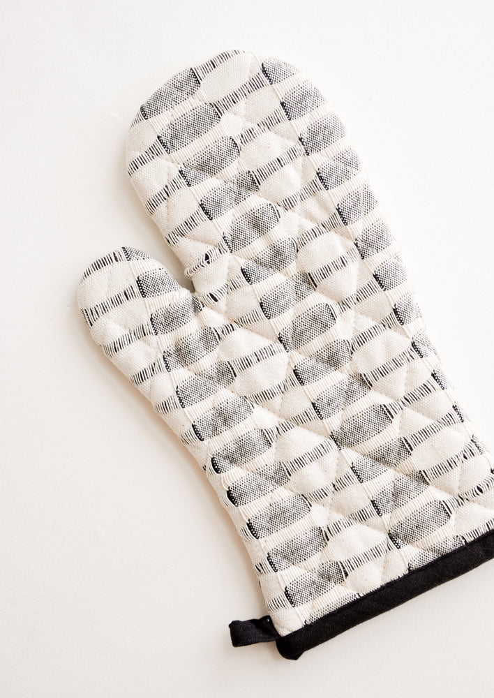 2: A black and white striped oven mitt.