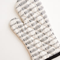 2: A black and white striped oven mitt.