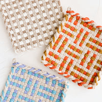 2: Hand knit potholders in assorted colors and patterns.