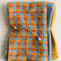 1: A set of three twine tied tea towels, one patterned two plain.