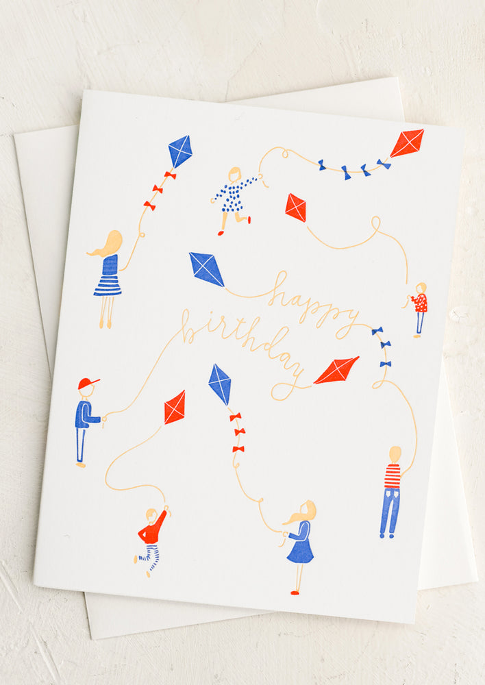 1: A letterpress card with children playing with kites, text reads "Happy Birthday".
