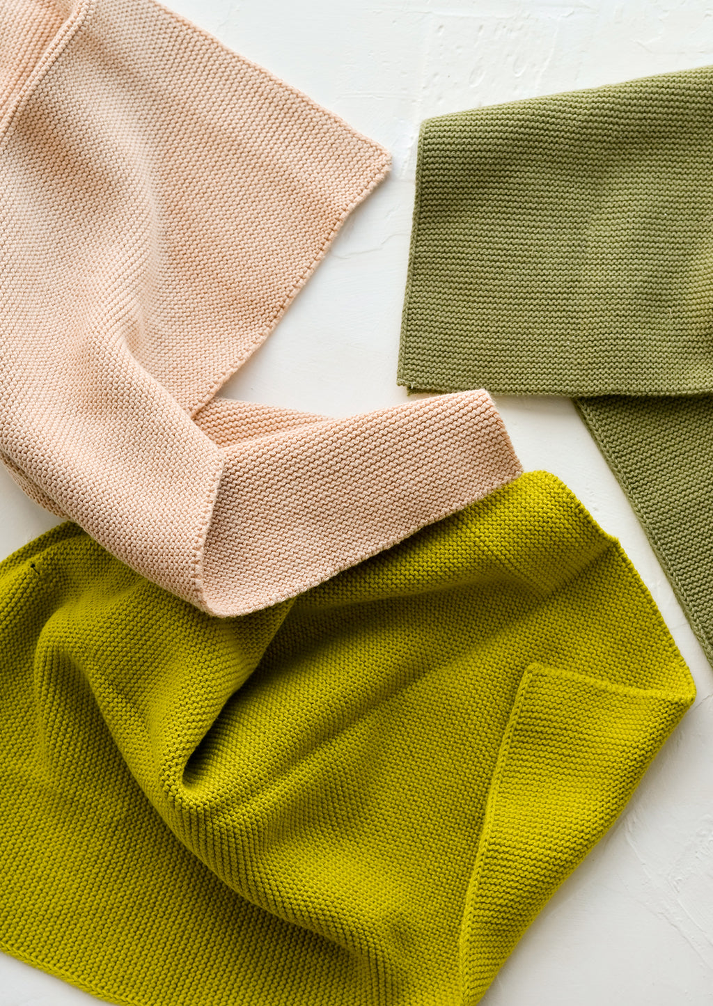 2: Three knit cotton dish towels in tan, olive and citron.