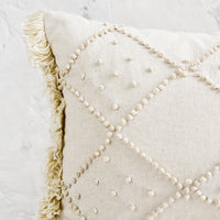 2: Knotted detailing on a linen lumbar pillow.