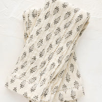 1: A pair of undyed cotton gauze napkins with grey floral motif and hemstitch detailing. 