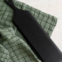 Forest: A woven tea towel in forest green with black grid pattern.