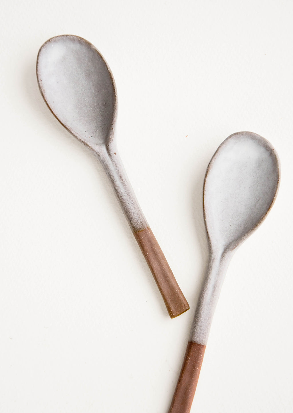 2: Ceramic soup spoons in earthy brown clay dipped in white glaze