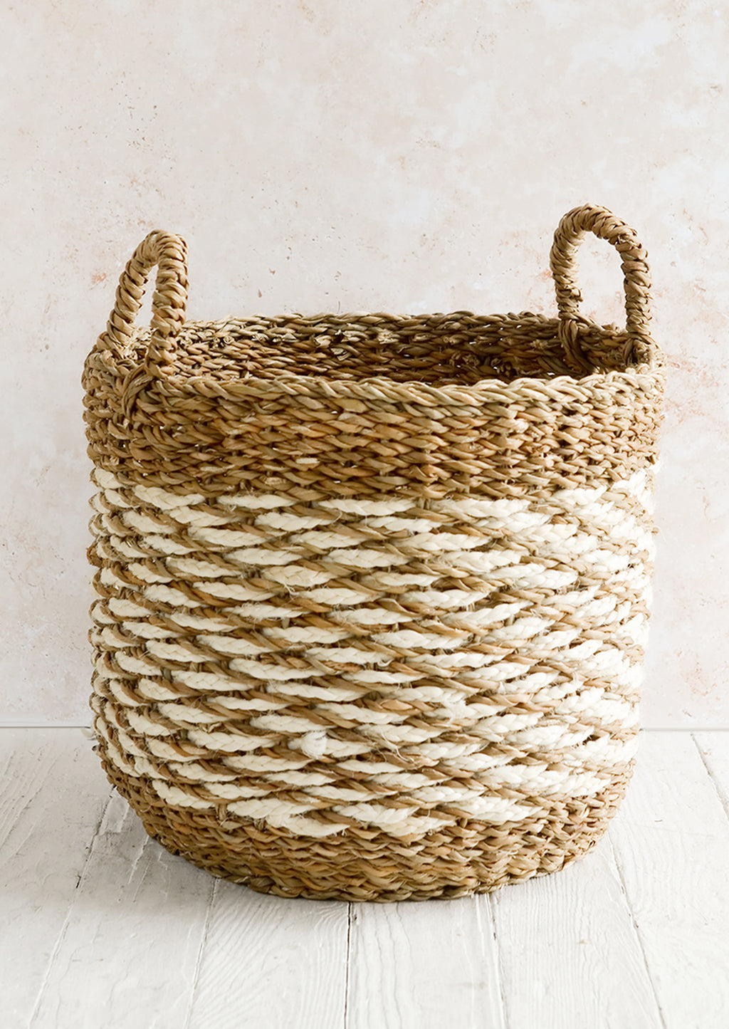 Large [$98.00]: A large open-top round storage basket made from seagrass with braided jute, featuring two handles at top.
