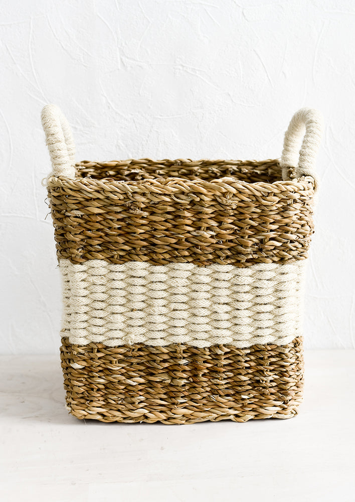 A square storage basket in woven straw and jute, medium size.