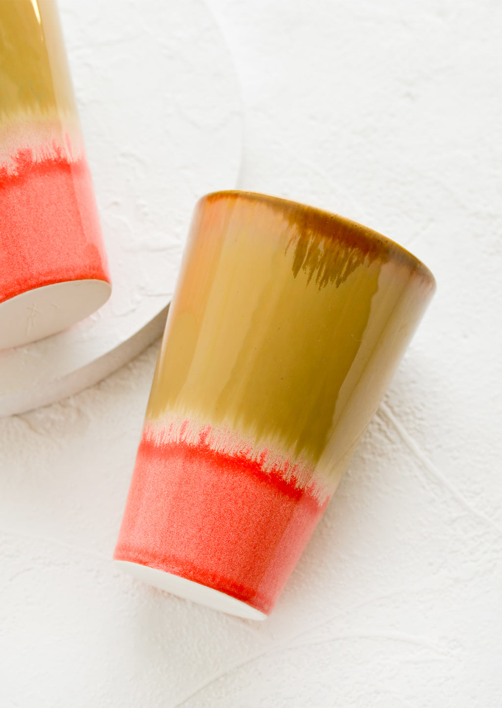Brown / Neon Pink: A ceramic cup in brown and pink.