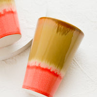 Brown / Neon Pink: A ceramic cup in brown and pink.