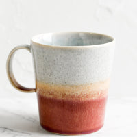 Cloud / Currant: A ceramic coffee mug with handle in speckled grey-blue and currant glaze.