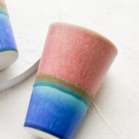 Pink / Bright Blue: A ceramic cup in pink and blue.