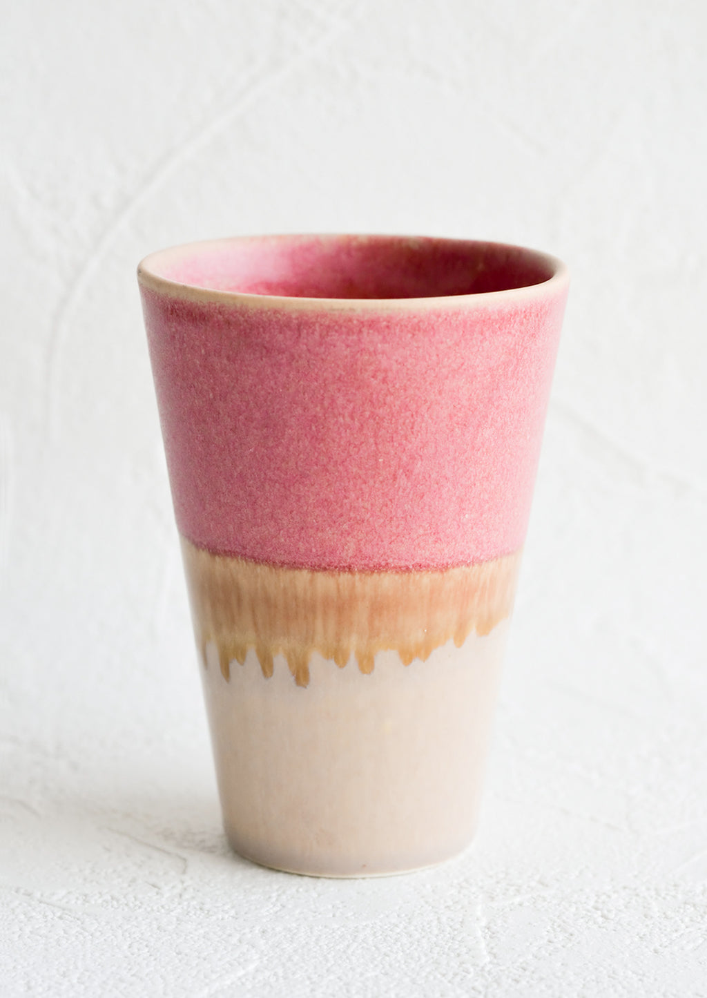 Dark Pink / Beige: A ceramic cup in pink and brown.