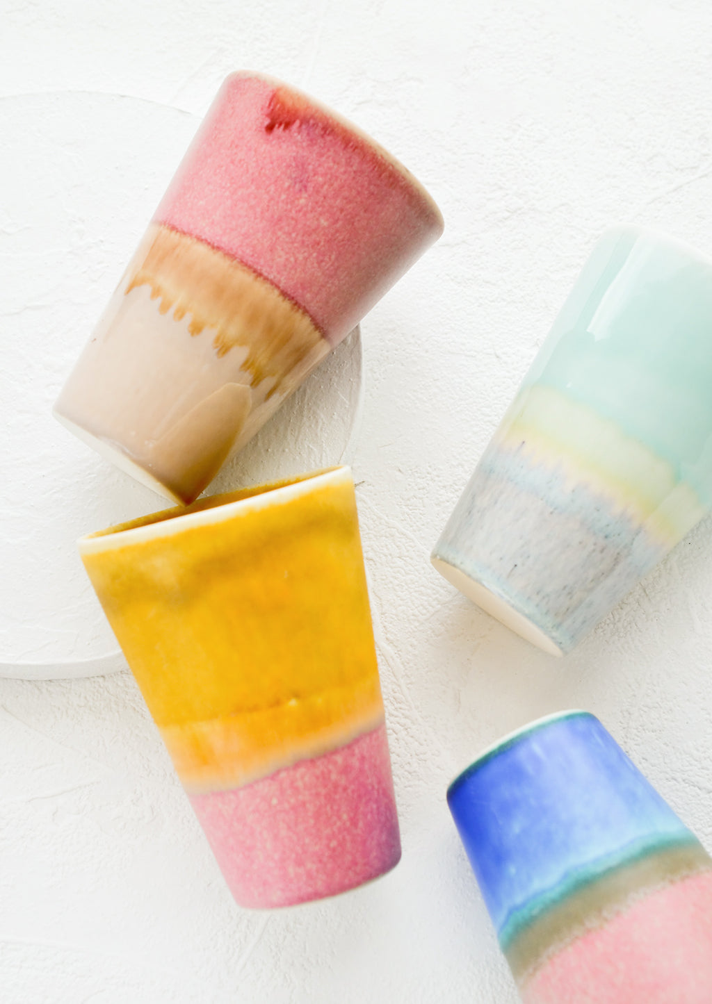 1: An assortment of colorful ceramic tumblers.