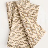 1: A pair of folded napkins with block printed labyrinth print on natural cotton.