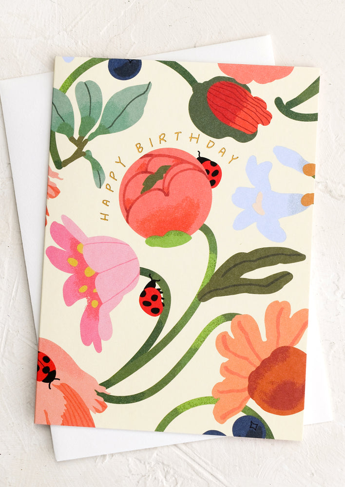 1: A floral print card with ladybugs reading "Happy Birthday".