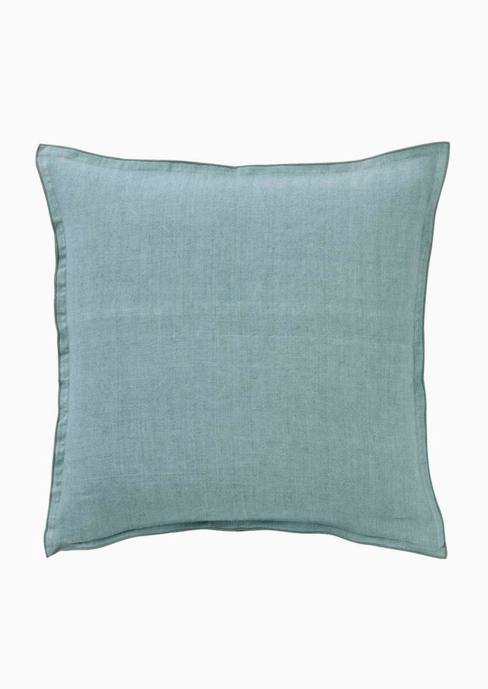 A solid linen pillow in lake blue.