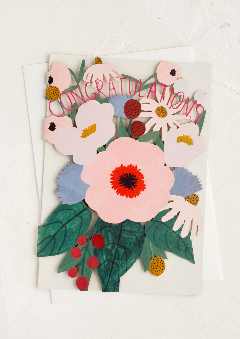 1: A greeting card with floral lasercut front reading "Congratulations".