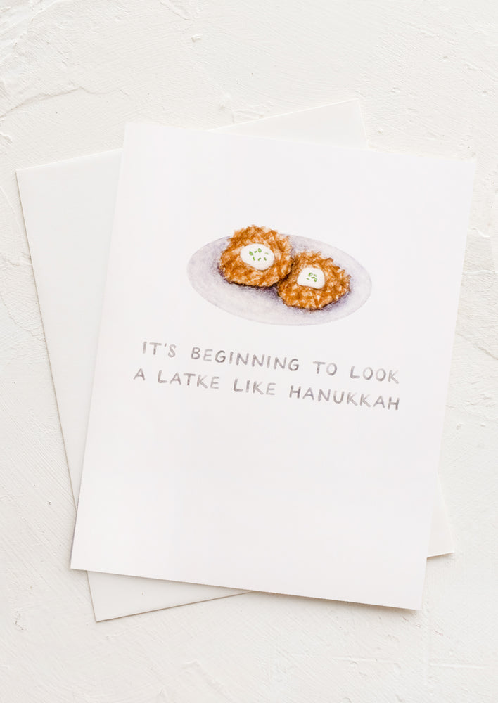 1: A greeting card with illustration of latkes and text reading "It's beginning to look a latke like Hanukkah".