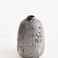 Large / Mercury: Heavily textured, tall ceramic bud vase in a metallic, crater-like dark grey glaze