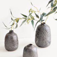 2: Group shot of heavily textured ceramic bud vases in dark metallic grey, styled with eucalyptus stem - LEIF