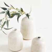 Small / Pumice: Group shot of textured ceramic bud vases in pumice grey, styled with eucalyptus stem