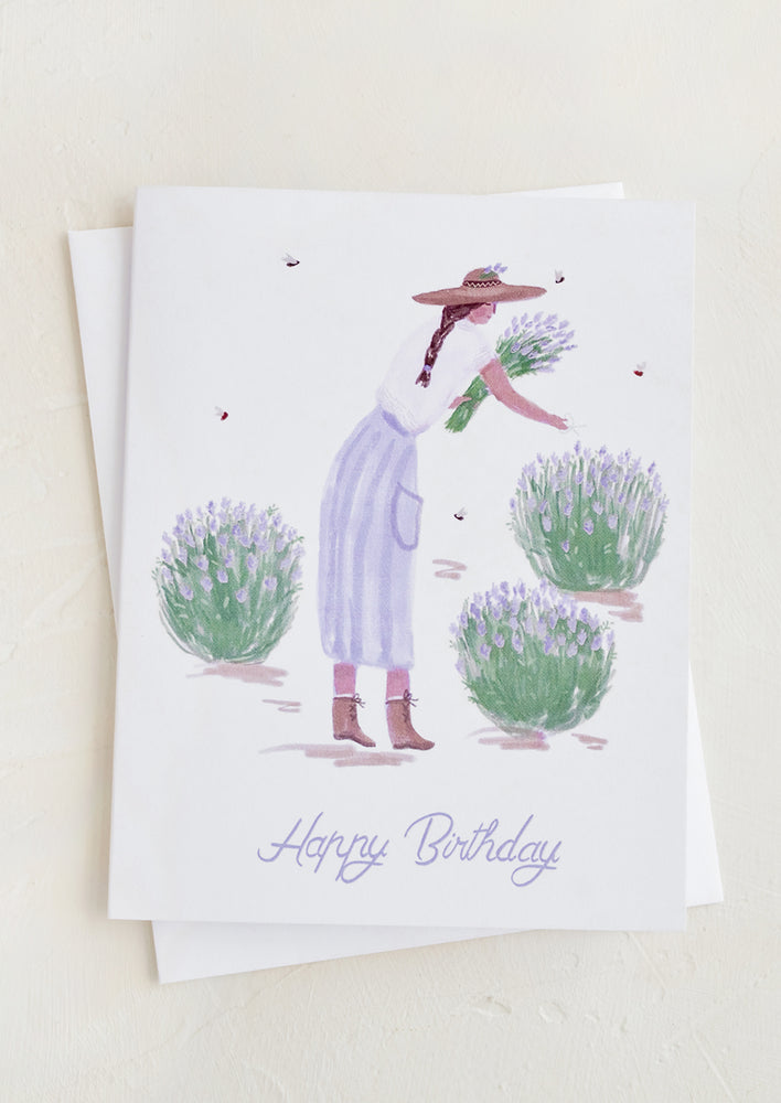 A birthday card with illustration of a woman harvesting lavender plants.